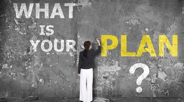 woman writing on wall that says what is your plan?