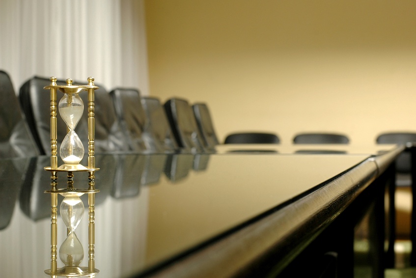 hourglass sitting on a conference table