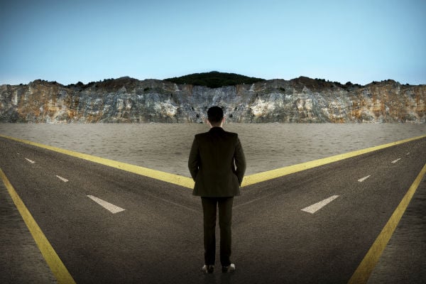 man standing at a crossroads