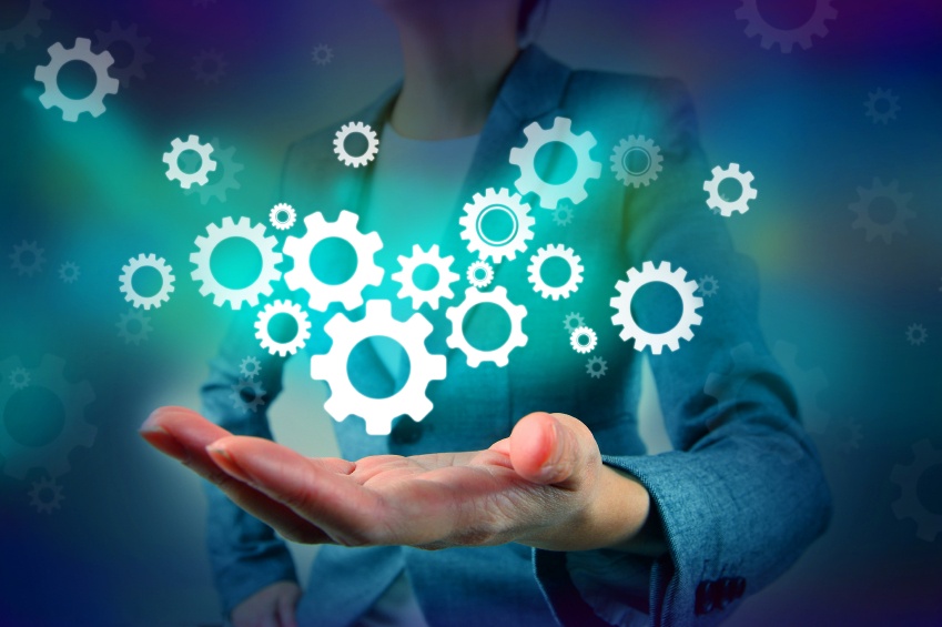 a hand holding gears to indicate concepts coming together