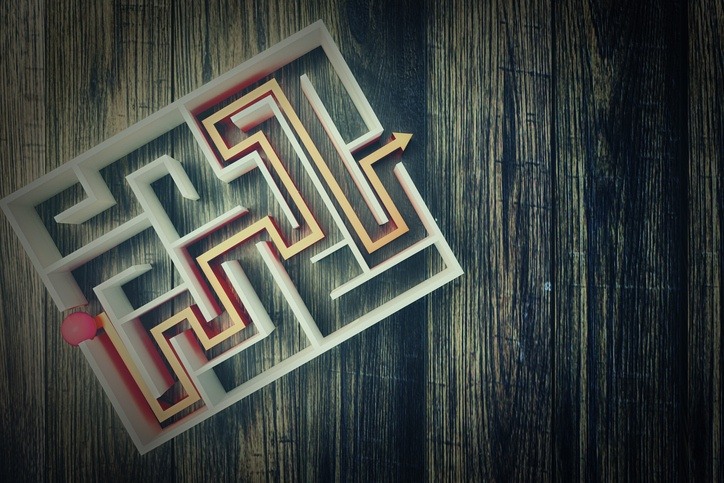 completed maze with an arrow on a table