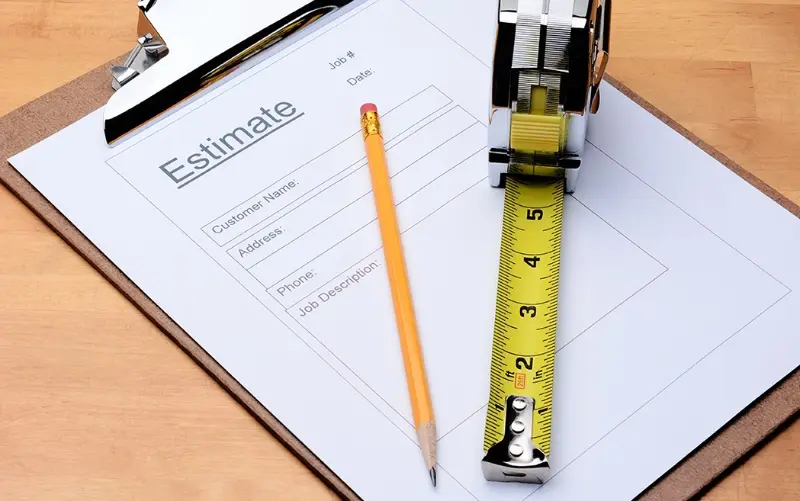 estimate paperwork on a clipboard with a pencil and tape measure