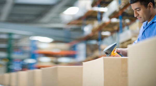 a man in a warehouse scanning a package