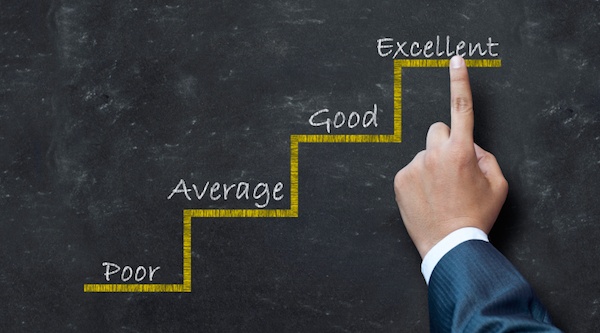 person pointing to chalkboard saying excellent