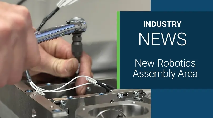 a male hand driving a bolt into a medical cart base in a surgical robotic system assembly room